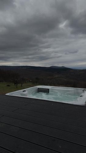 a hot tub sitting on top of a building at Air Cabin, Cabana tip A-frame in Șerani, Bihor in Şerani