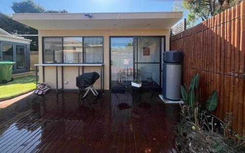 a house with a patio with a fence at Guest suite in Brighton in Melbourne