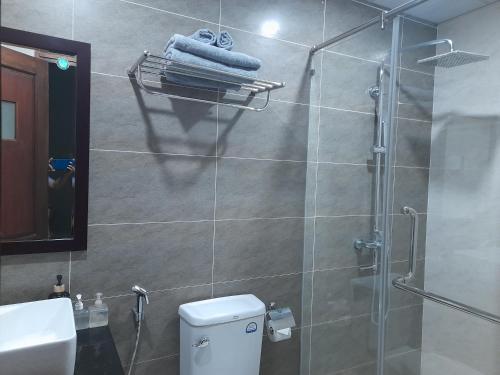 a bathroom with a shower with a toilet and a sink at Happy Home in Nha Trang