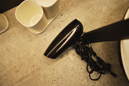 a hair dryer sitting on top of a counter at Apartamenty na Zatorskiej by Housine in Zator