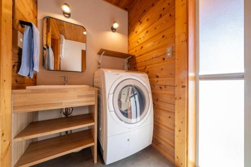 a bathroom with a washing machine and a sink at Calm villa 富士山中湖 in Yamanakako