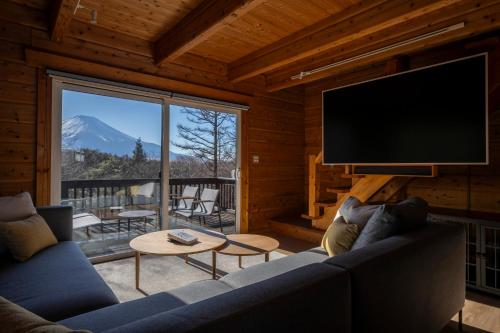 a living room with a large flat screen tv at Calm villa 富士山中湖 in Yamanakako
