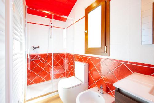 a bathroom with a toilet and a sink at Poggio Diavolino - Suvereto in Suvereto