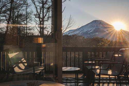 a view of a snow covered mountain from a balcony at Calm villa 富士山中湖 in Yamanakako