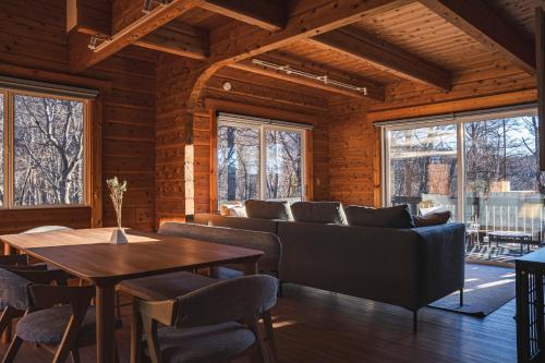 a living room with a couch and a table at Calm villa 富士山中湖 in Yamanakako