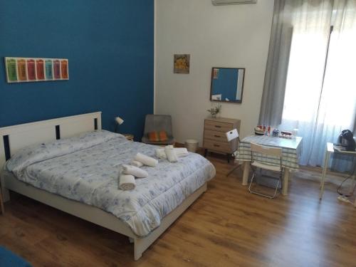 una camera da letto con un letto con cuscini bianchi di A UN PASSO DAL DUOMO " con GARAGE AUTO GRATUITO" a Catania
