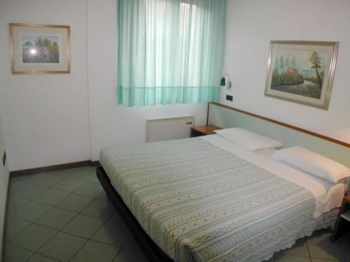 A bed or beds in a room at Residence Mediterraneo