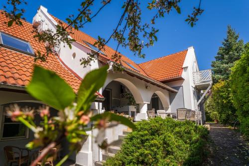 a house with an orange roof at BELYSIUM B&B Wine&Relax Vendégház in Gyenesdiás