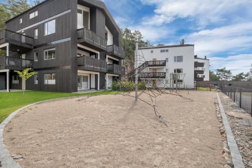 a tree limb in front of a building at Åros Seaside Apartment with Pool, Jacuzzi & Sauna in Kristiansand