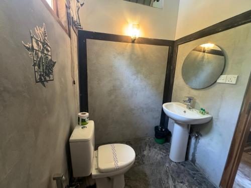 a bathroom with a toilet and a sink at Steps Garden Resort in Negombo