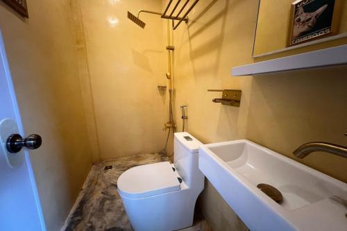 a small bathroom with a toilet and a sink at Sibsib Baybayin Beach Resort in Tanza