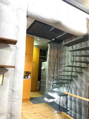 a hallway of a building with a table and chairs at Ikebukuro sta. 10mins walk. Rough style 88㎡ House in Tokyo