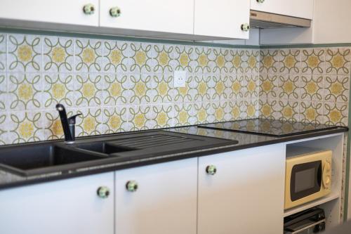 a kitchen with a sink and a microwave at Sun Beach 0603 in Sint-Idesbald