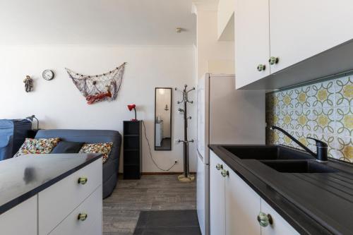 a kitchen with a sink and a couch at Sun Beach 0603 in Sint-Idesbald
