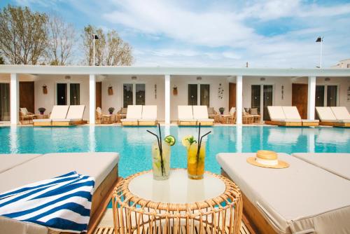 a resort pool with a table with a vase on it at Cavomarina Beach- Adults Only in Kavos