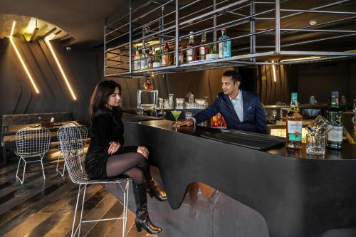 a man and a woman sitting at a bar at Ramada Encore by Wyndham Ambala GT Road in Ambāla