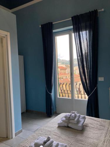 a bedroom with a bed and a large window at Oltre il Blu in La Spezia