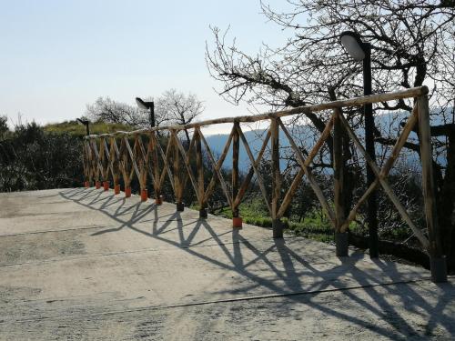 a wooden fence on a walkway with a view of the mountains at casa Dani - accogliente appartamento Catanzaro in Catanzaro