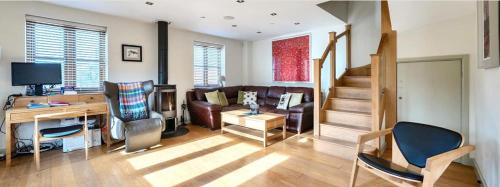 a living room with a couch and a table at Luxury Home on Wellesley Park Near Wells in Wells