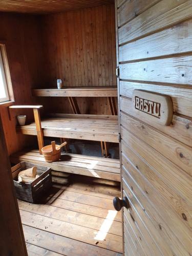 an inside of a sauna with a sign on the door at Camp Caroli Wooden Cabins in Jukkasjärvi