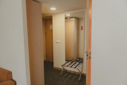 a room with a hallway with a bench in it at Park Hotel Latgola in Daugavpils