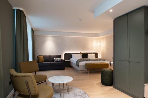 a hotel room with a bed and a couch at Designhotel am Stadtgarten in Freiburg im Breisgau