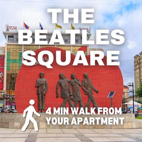 a statue of the beatles square with a man walking past it at Zaya Stays in Ulaanbaatar