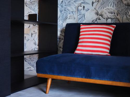 a blue bench with a red and white striped pillow at Hotel Carillon in Baveno