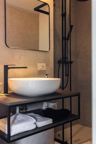 a bathroom with a white sink and a mirror at Hotel Carillon in Baveno
