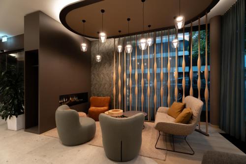 a living room with chairs and a large window at Designhotel am Stadtgarten in Freiburg im Breisgau