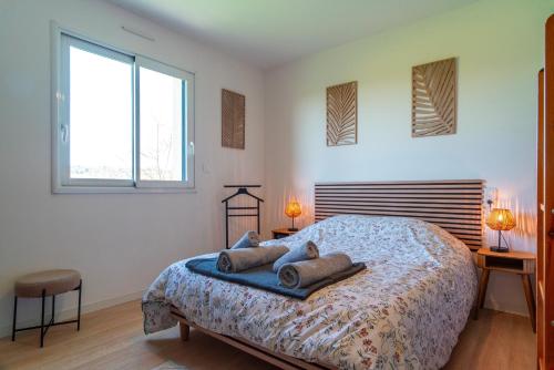 a bedroom with a large bed with two windows at Dreon Ker - Calme à deux pas du bourg in Plomodiern