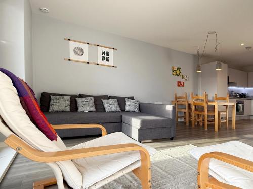a living room with a couch and a table at William place in Wembley - Close to Wembley Stadium & Wembley Arena, 12 mins away from Central London by train in London