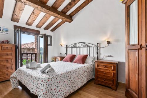a bedroom with a bed and a dresser and a window at Casa Rural Adrimar in Selorio