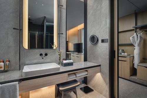 a bathroom with a sink and a mirror at Crowne Plaza Hangzhou Riverside by IHG in Hangzhou