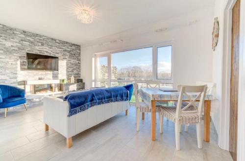a living room with a table and a couch at Sunvalley hideaway in Saundersfoot
