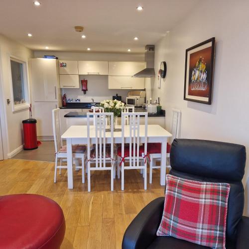 a kitchen and dining room with a table and chairs at Beach View Ballycastle Escape in Ballycastle
