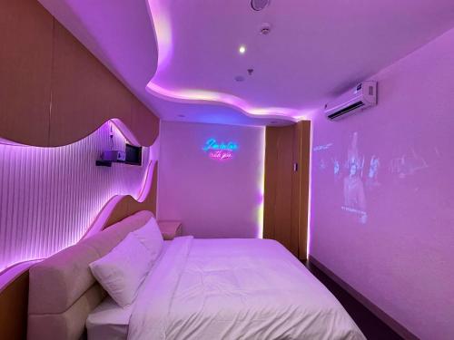 a room with a bed and a purple ceiling at Star Night Hotel and Apartment in Hanoi