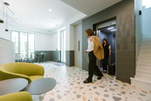 a man and a woman standing in a hallway at Luna Residence Villa in Timişoara