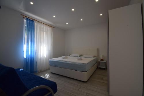 a small bedroom with a bed and a mirror at Apartments Bella Vista Lilly in Portorož