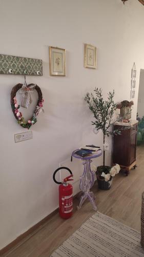 a room with a table and a wreath on the wall at Dolce Dimora Siena in Siena
