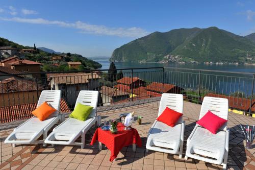 a group of chairs and a table with colorful pillows at Hotel Bellavista Meublè in Monte Isola