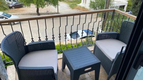 two chairs and a table on a balcony at olives tree in Datca