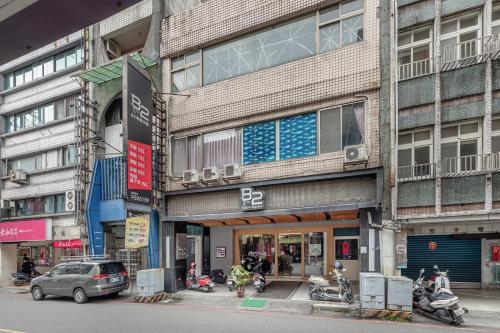 a building with cars parked in front of it at 桔子小屋 in Luodong