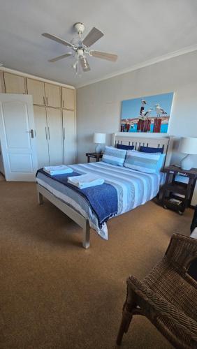 a bedroom with two beds and a ceiling fan at MADRIKO 36 Cozy self catering 2 bedroom apartment in Langebaan
