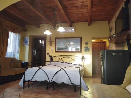 a bedroom with a bed and a living room at Dimora Pietra Antica in Milis