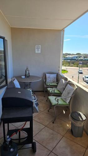 a room with a couch and a table and a window at MADRIKO 36 Cozy self catering 2 bedroom apartment in Langebaan