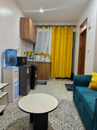 a living room with a couch and a table at Koki Bnbs Kamakis in Ruiru