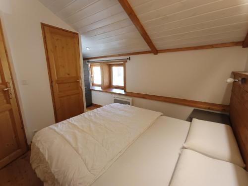 une petite chambre avec un lit et une fenêtre dans l'établissement Appartement cosy, 100m des pistes et commerces, 4 pers, 30m², Parking, Balcon plein sud - FR-1-445-202, à Montgenèvre