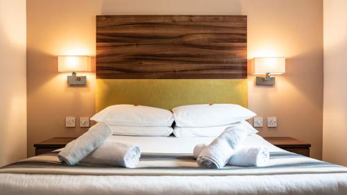 a large bed with two pillows and two lamps at Livingston Lodge Hotel in Livingston