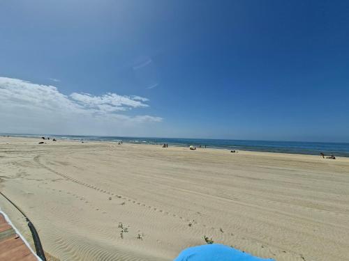 a view of a beach with people on it at Apartamento con piscina in Matalascañas
